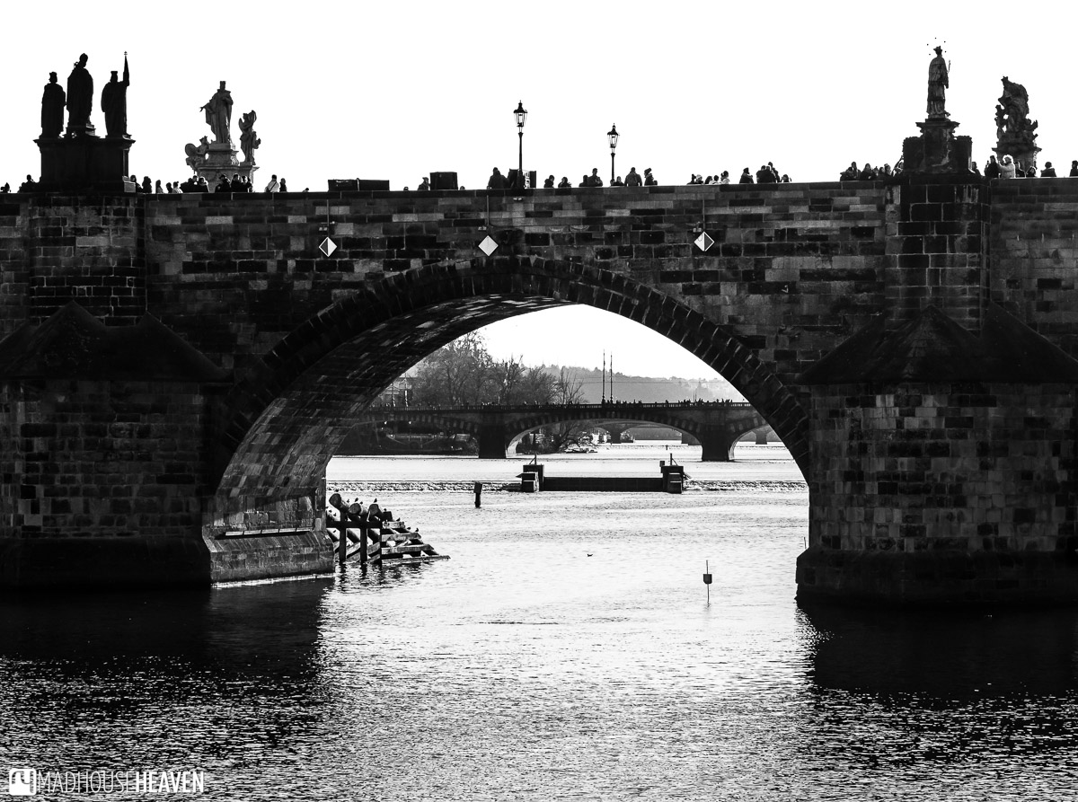 Black and white image of Charles Bridge, over the Vltava River, in Prague